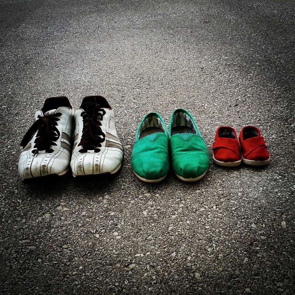 Shoes of family announcing pregnancy.